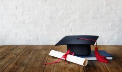 Mortar board and a graduation diploma