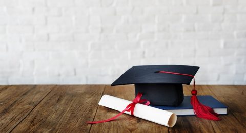 Mortar board and a graduation diploma